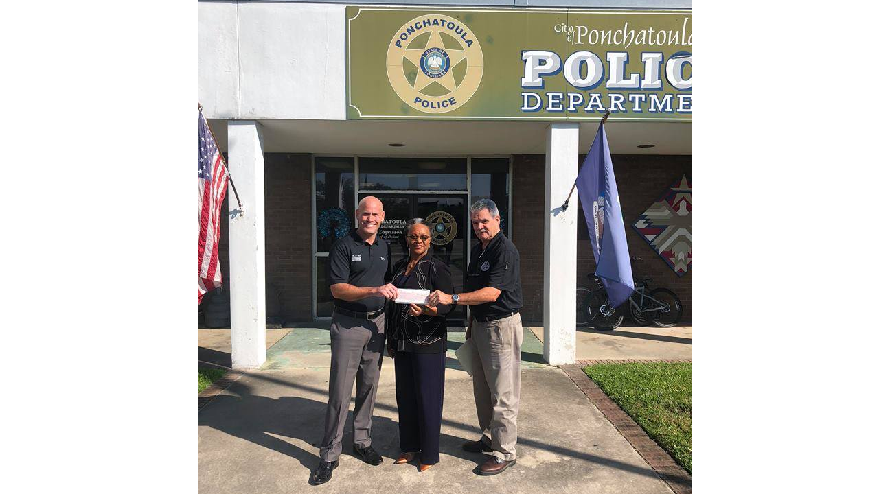 Entergy Louisiana Customer Service Representative Eunice Harris presents the grant check to Ponchatoula Police Chief Bry Layrisson (left) and Ponchatoula Police Assistant Chief Jim Betbeze (right). 